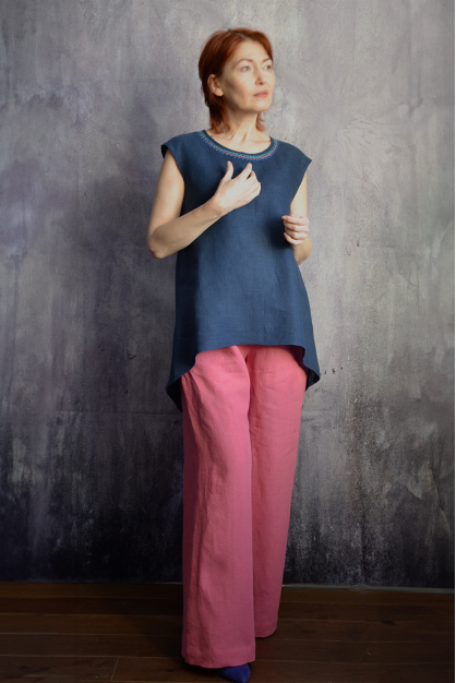 French pink. Linen trousers are straight and a blue top with embroidery